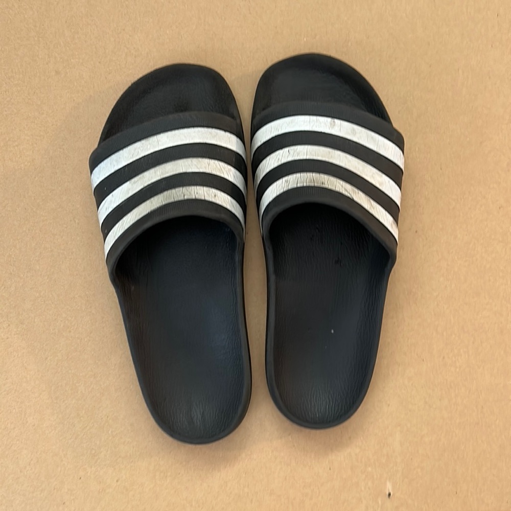 Used black adidas slides